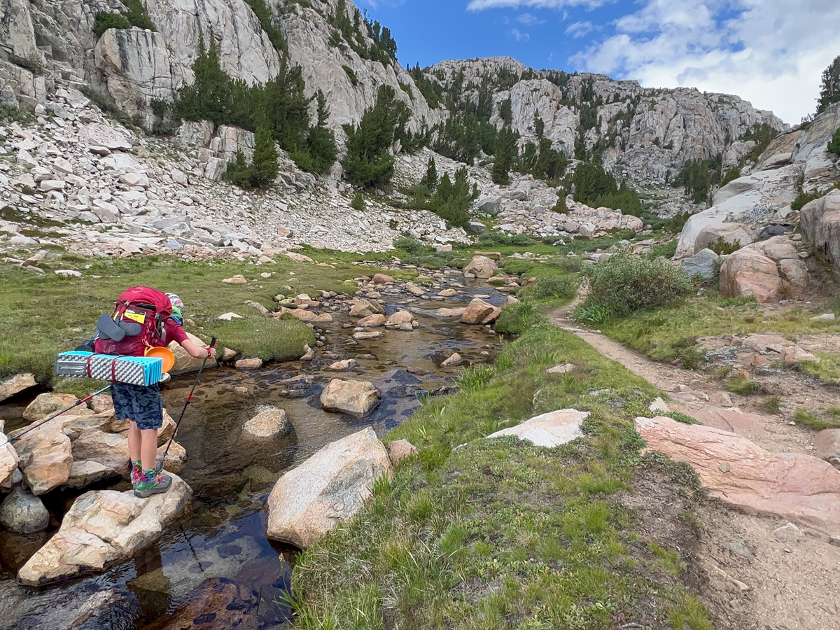 Kid looking in a stream on the JMT