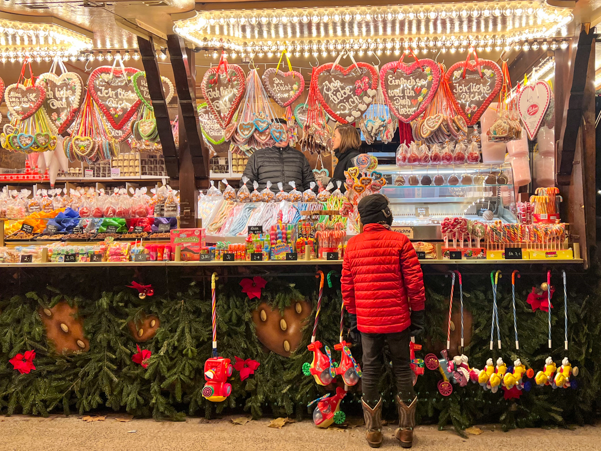 Kid at sweet stall at Christmas Market in Germany