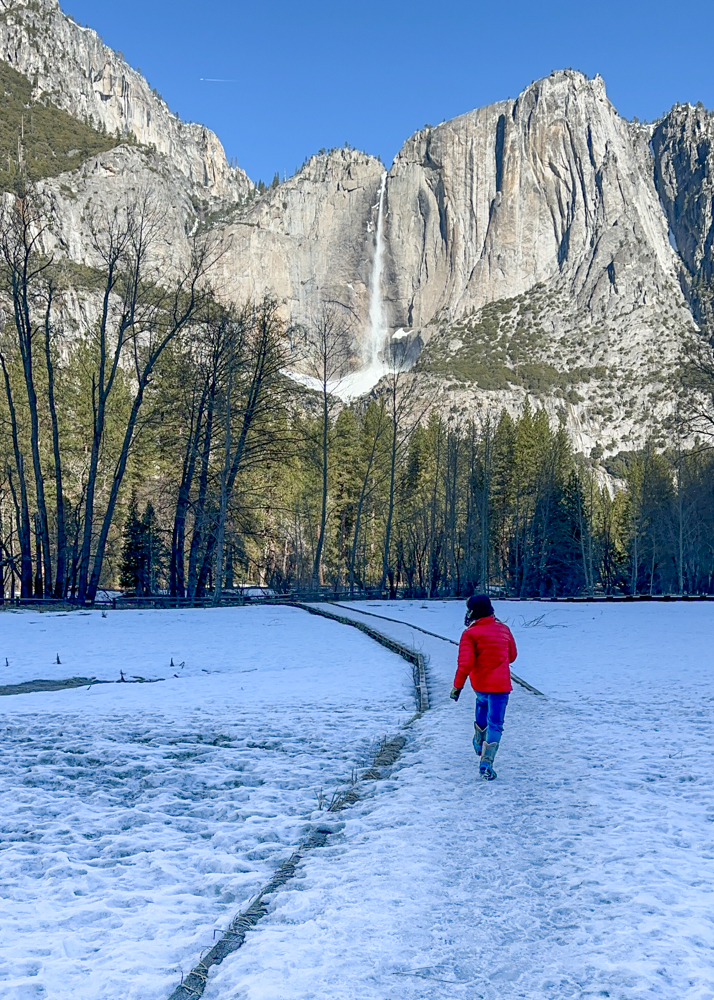 kid walking on snowy boardwalk at Yosemite in winter